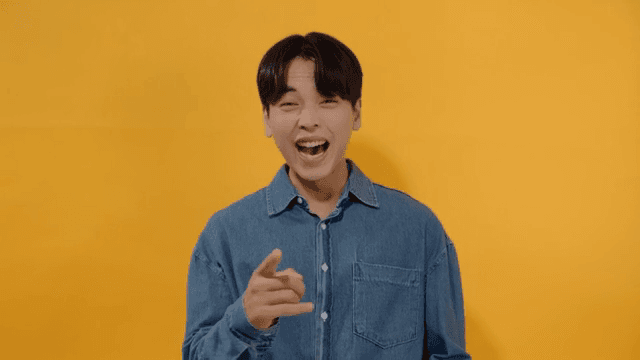 Man in denim shirt laughing out loud, expressing joy