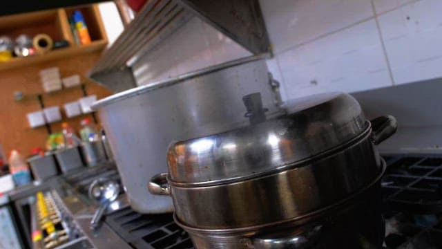Cooking pots on stove in commercial kitchen