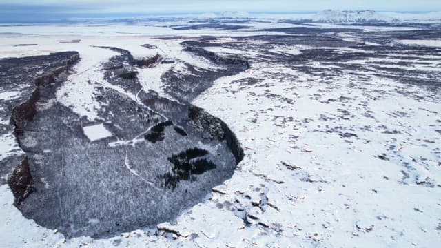 Snow-covered landscape with cliffs
