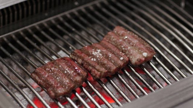 Flipping Steaks on a Hot Grill