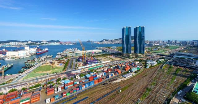 Panoramic day-to-night view of a bustling Port of Busan