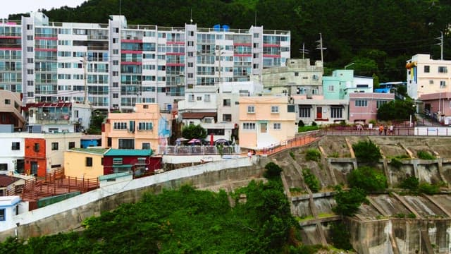 Colorful buildings nestled against a lush mountain