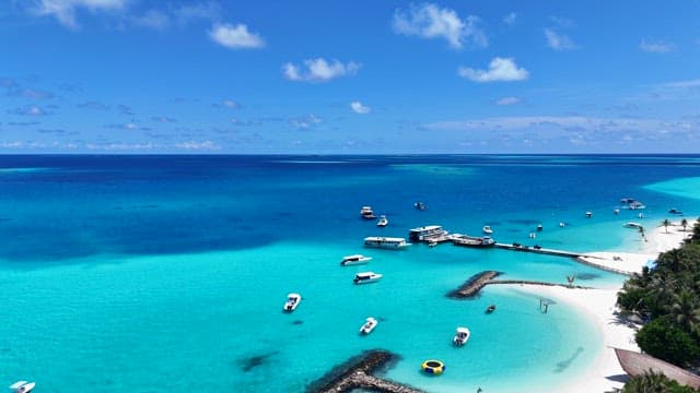 Tropical beach with boats and clear water