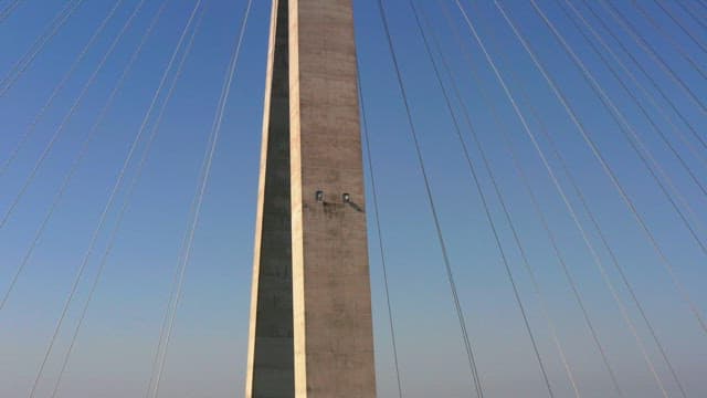 Tall bridge tower with cables against a clear sky