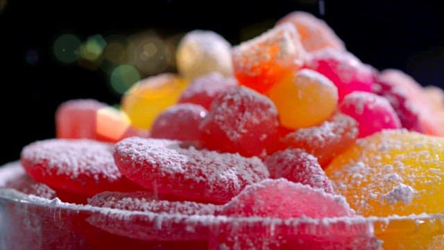 Colorful jelly candies sprinkled with powdered sugar