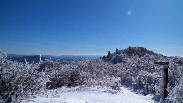 View from a snow-covered mountaintop on a sunny winter day