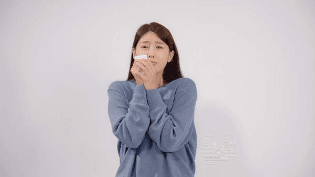 Sad woman crying with a tissue