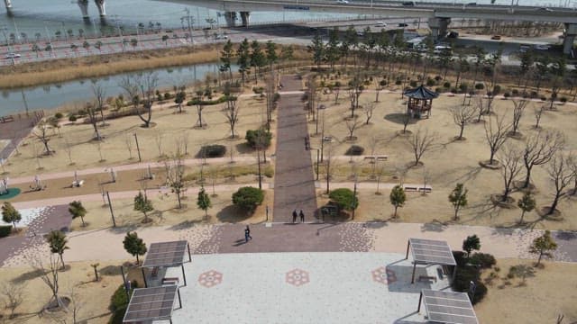 Park with pathways and a river nearby