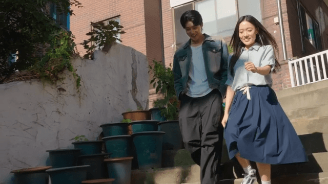 Couple walking down sunny stairs
