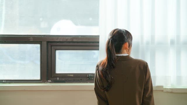 Student standing by the classroom window