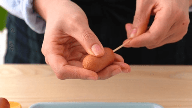 Scene of putting a sausage on a toothpick