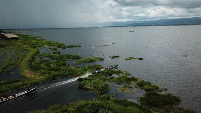 Boats Speeding Across a Scenic Inle Lake