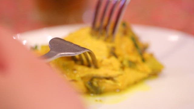 Delicious chicken dish being picked up with a fork