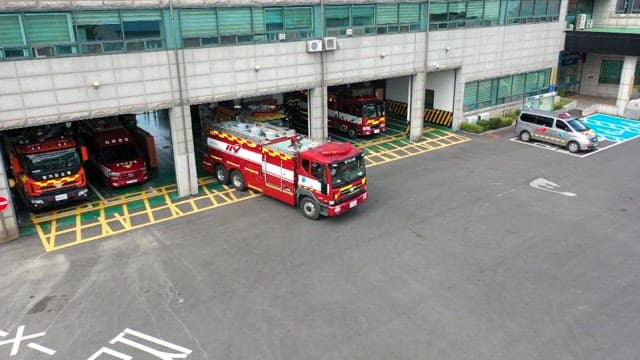 Fire truck leaving the fire station and driving on the road