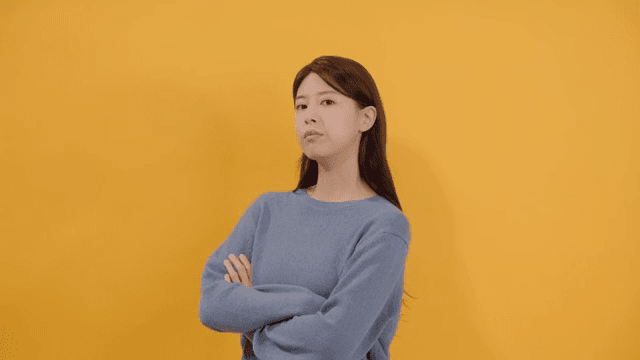 Long haired woman posing confidently with arms crossed