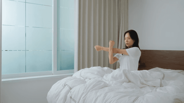 Woman waking up in the morning and stretching