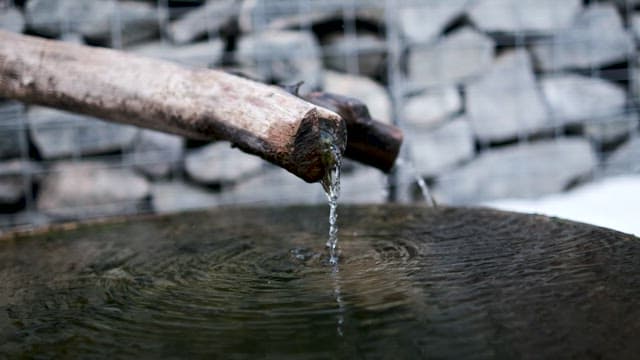 Stream of Water Falling Down From Wooden Waterway