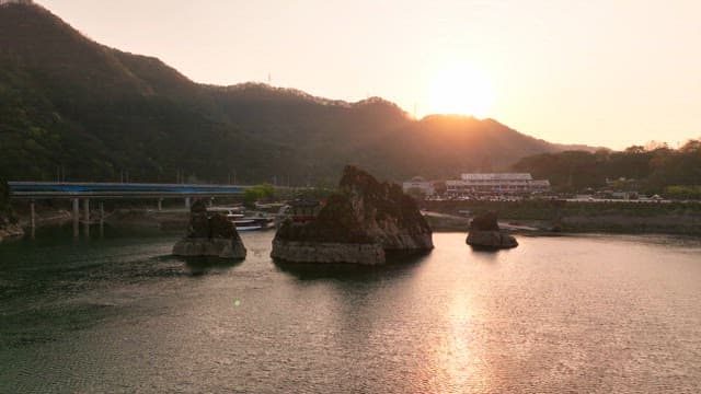 Sunset over a serene river with mountains