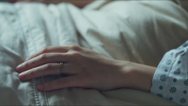 Patient's Hands Covering a Blanket