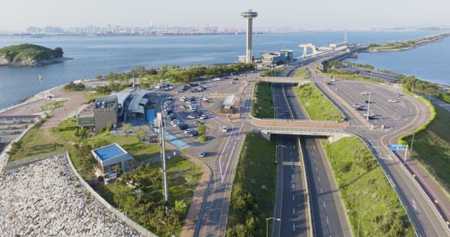 Long bridge connecting to a city skyline