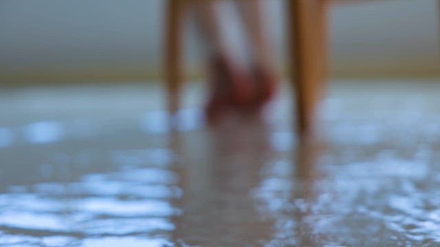Person Soaking His Feet in Running Water on the Floor
