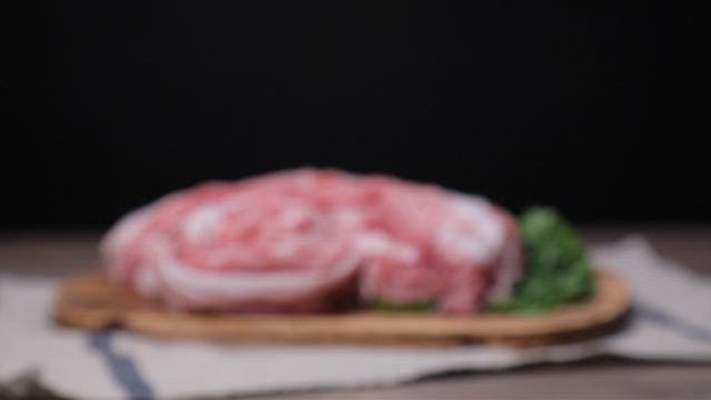 Fresh pork slices on a wooden board
