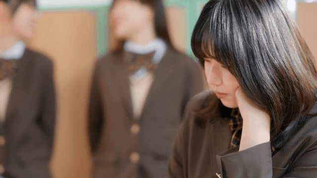 Student sitting and watching their friends