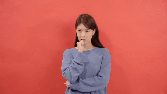 Woman expressing anxiety by biting her nails