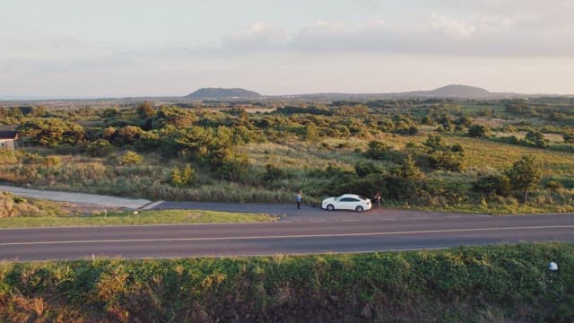 Rural road with cars and wind turbines
