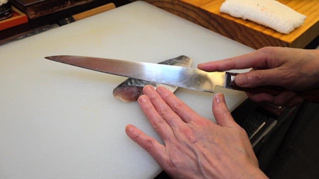 Slicing Fish on Kitchen Cutting Board