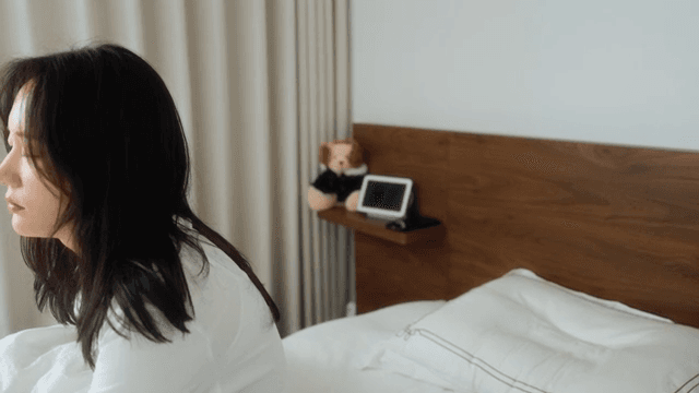 Woman waking up next to digital tablet