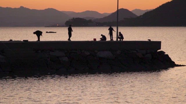 People Fishing on the Coast of Suncheon Sea at Sunset