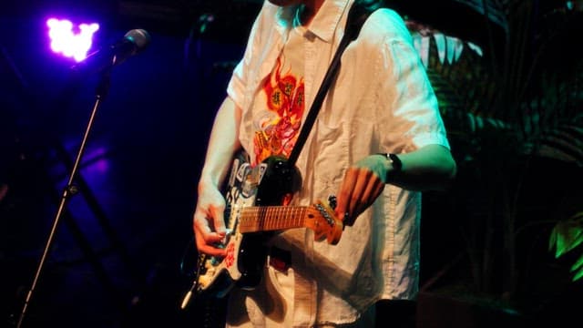 Guitarist Tuning Guitar on Stage