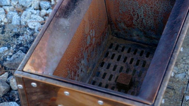 Starting a fire in an outdoor metal stove with torch