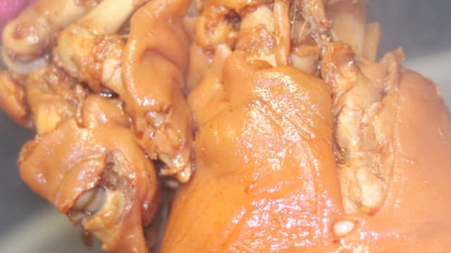 Pig's feet cooked in a large cauldron