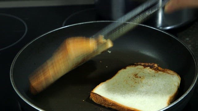 Toasting bread slices in a frying pan