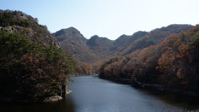 Serene autumn landscape with mountain and river
