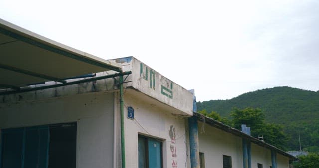 Abandoned Rural Building Against a Hillside