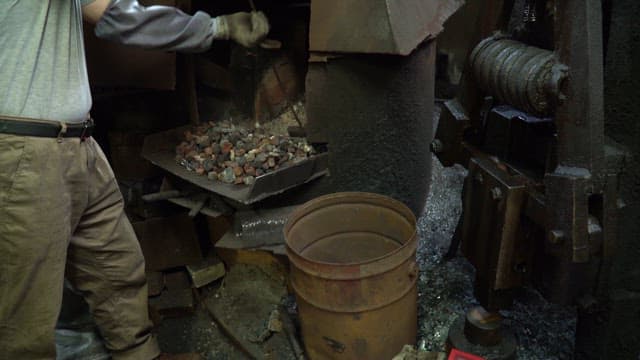 Coal being shoveled in a furnace