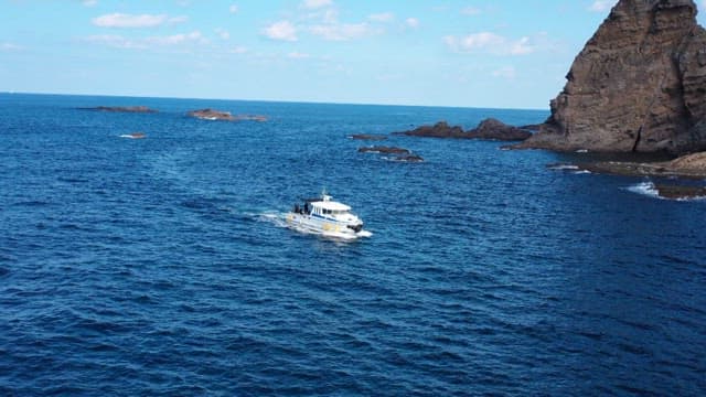 Boats Navigating Around Majestic Rocky Islands