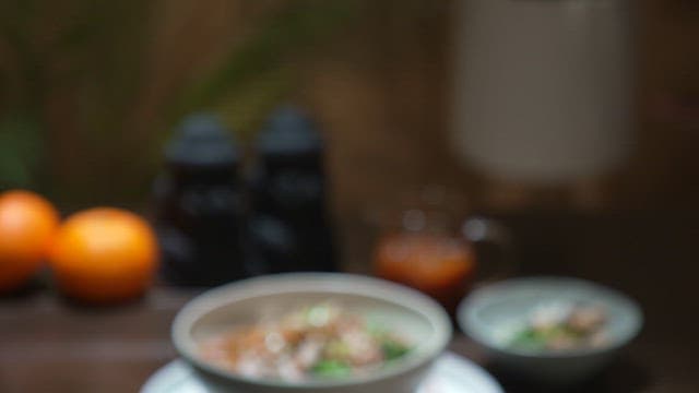 Dish with fresh conch as a garnish on a wooden table