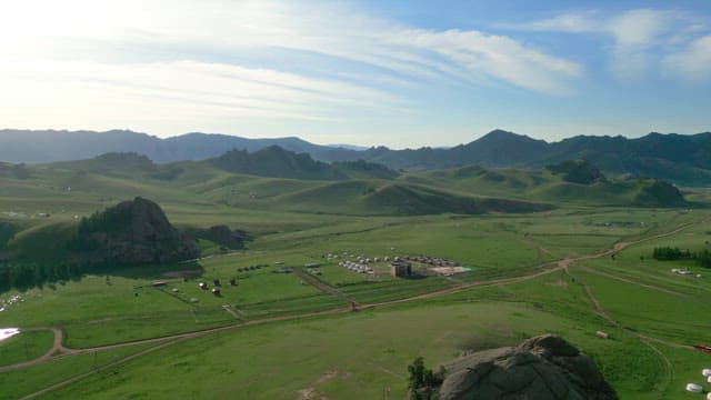Vast green landscape with distant mountains