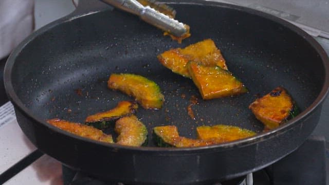 Slices of Pumpkin Being Fried in a Pan