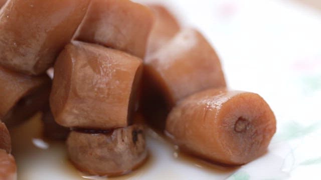 Deliciously braised mushroom in soy sauce served on a white plate