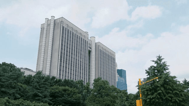 A cityscape with tall buildings and trees