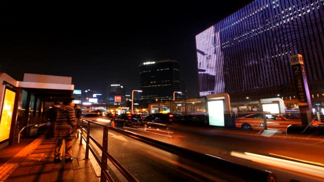 Night view of the busy city traffic and taxi stand