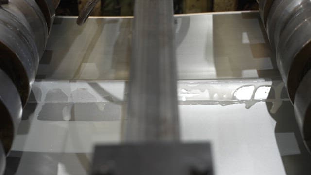Metal sheet being processed in a factory
