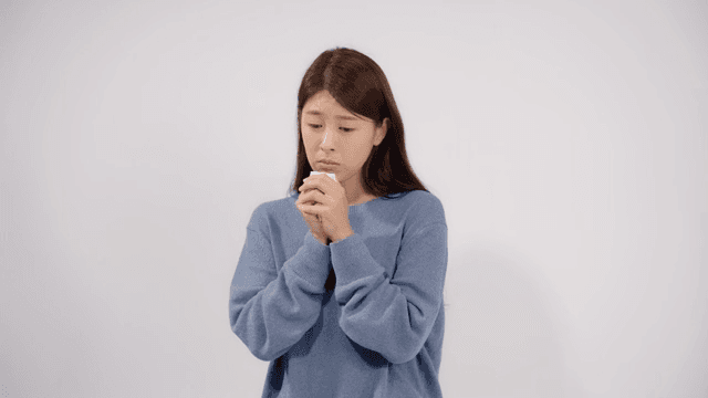 Sad woman crying with a tissue