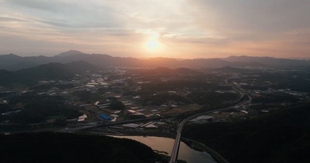 Rural Sunset Landscape with River and Road