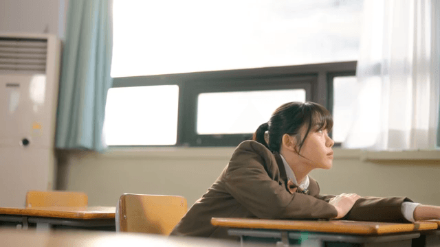 Student resting in a classroom
